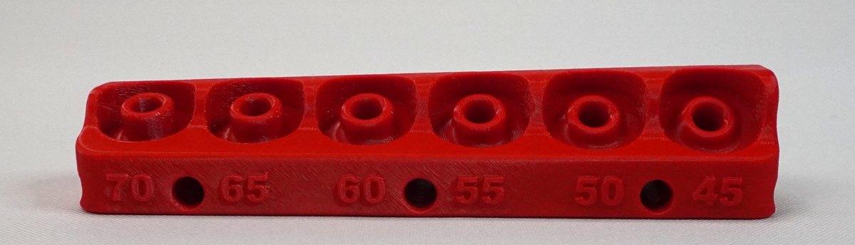 Top of a red V6: six angled slots with 70, 65, 60, 55, 50 and 45 printed beside them