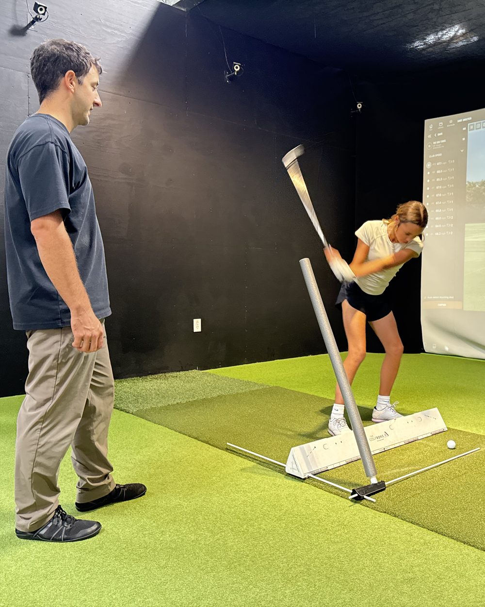 Sebastian coaching a junior golfer with the V6 at Portland Indoor Golf Club